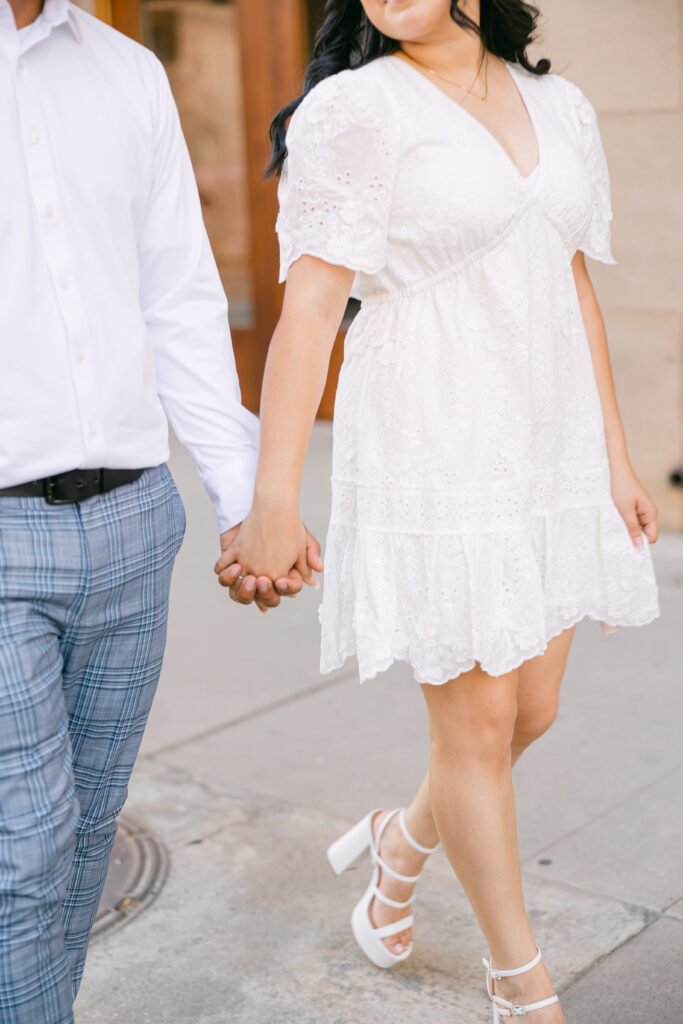 couple holding hands during their downtown phoenix engagement session