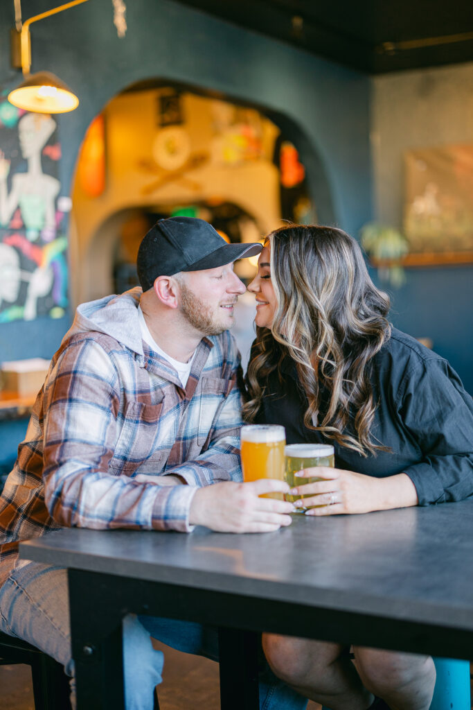 couple enjoying a beer in Flagstaff, Arizona for their engagement session
